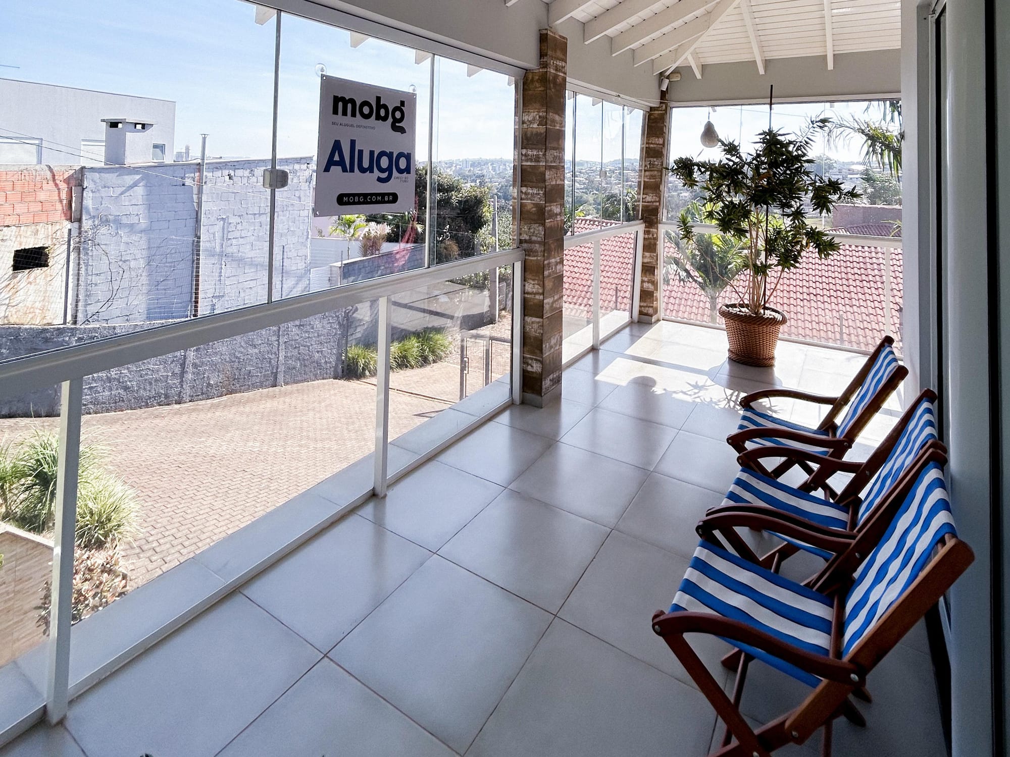 varanda de um apartamento aconchegante com placa de aluguel de imovel